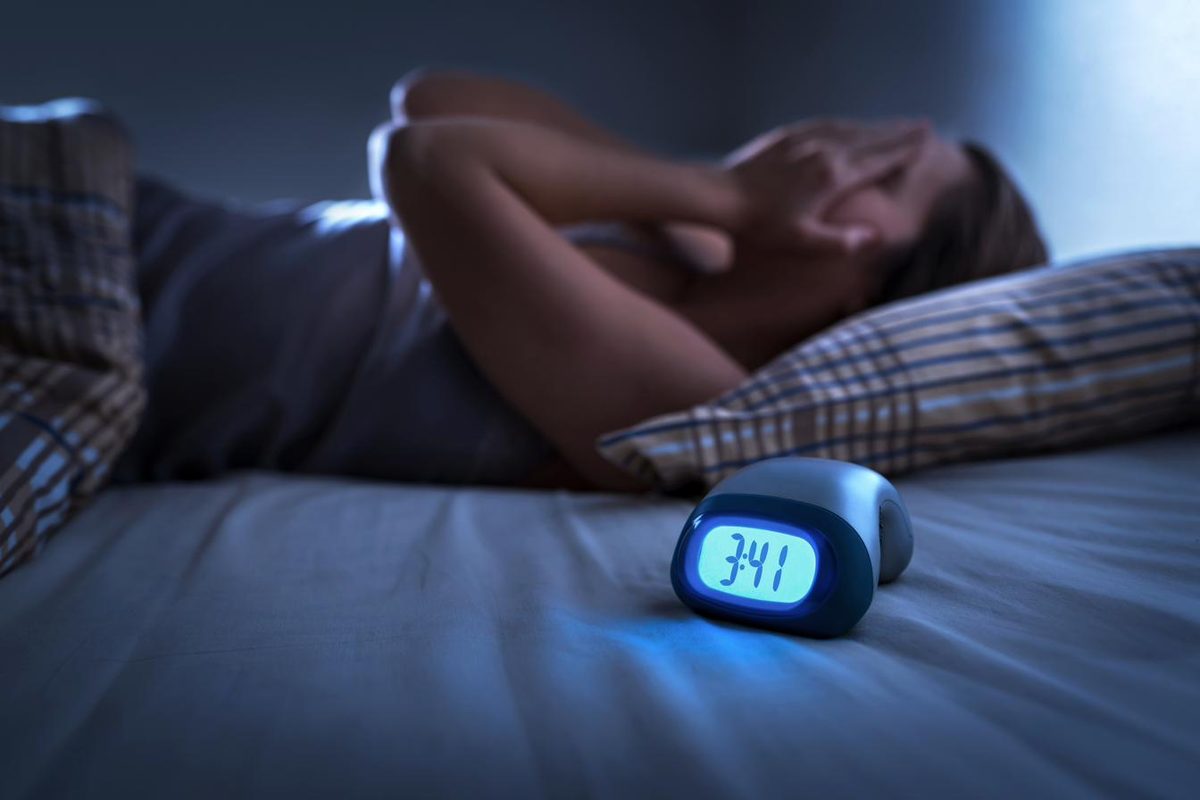 Woman lying awake at night with insomnia — acupuncture for insomnia and sleep difficulties in Boca Raton, Ronen Rosenblatt Nir