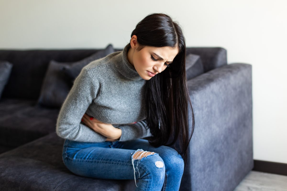 Woman with IBS abdominal pain and cramping - acupuncture treatment in Boca Raton by licensed acupuncturist Ronen Rosenblatt Nir