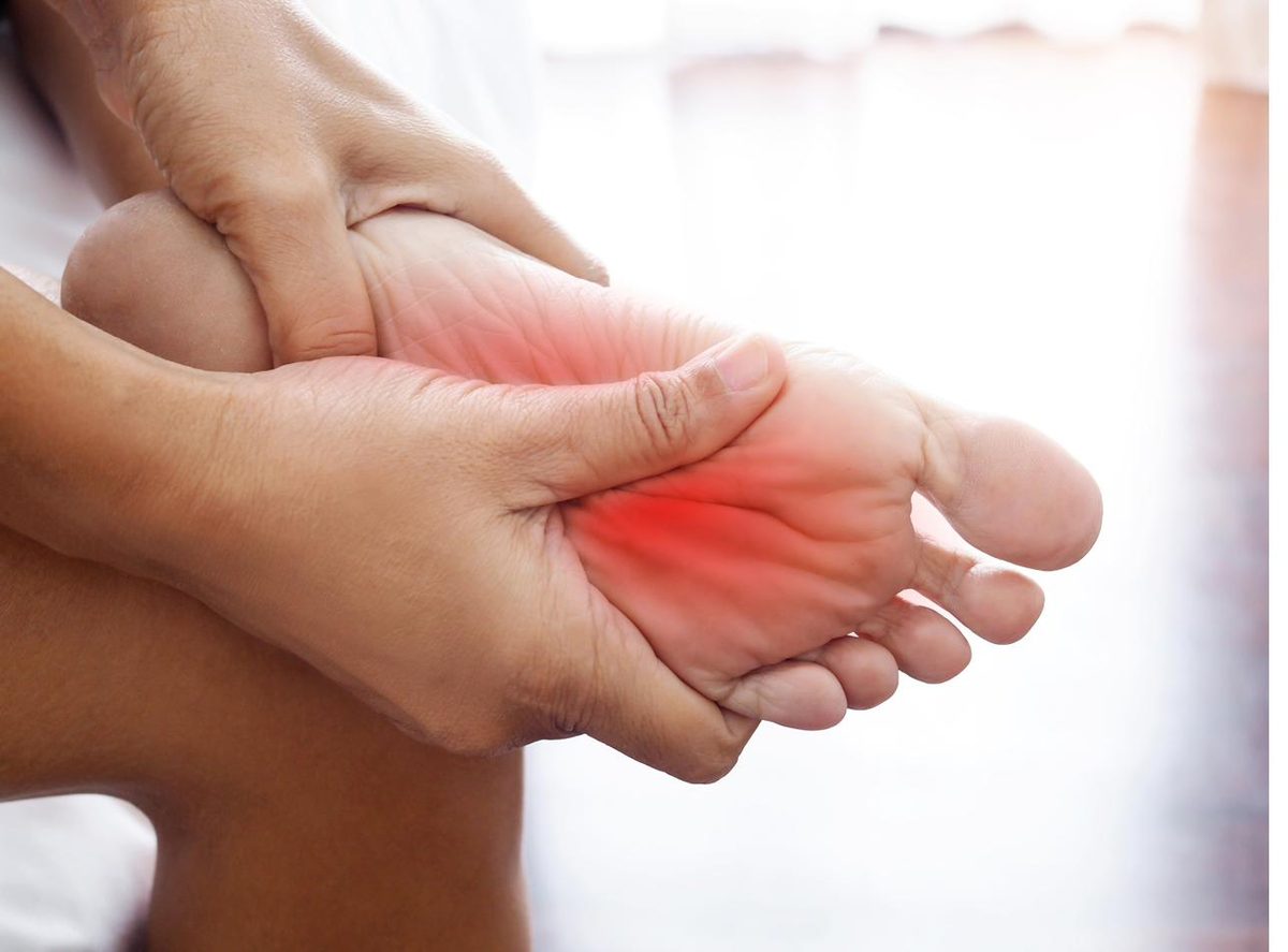 Person holding a foot with highlighted nerve pain — acupuncture for peripheral neuropathy in Boca Raton by Ronen Rosenblatt Nir