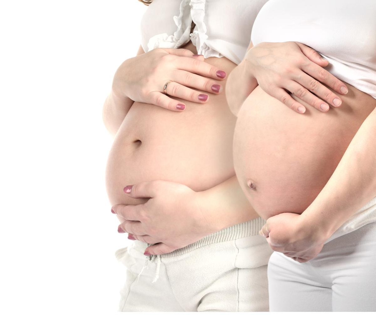 Two pregnant women holding their bellies — acupuncture support throughout pregnancy in Boca Raton by Ronen Rosenblatt Nir