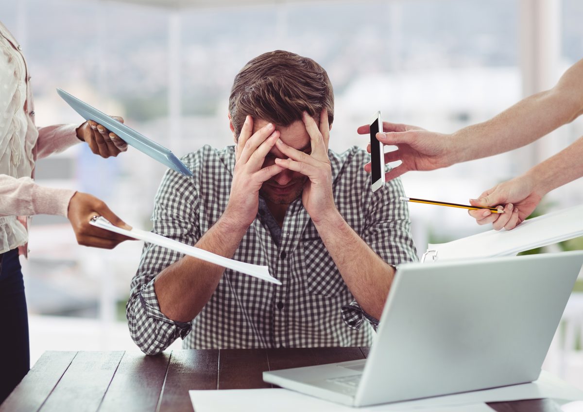 Man overwhelmed by work stress and multiple demands - acupuncture for stress relief in Boca Raton